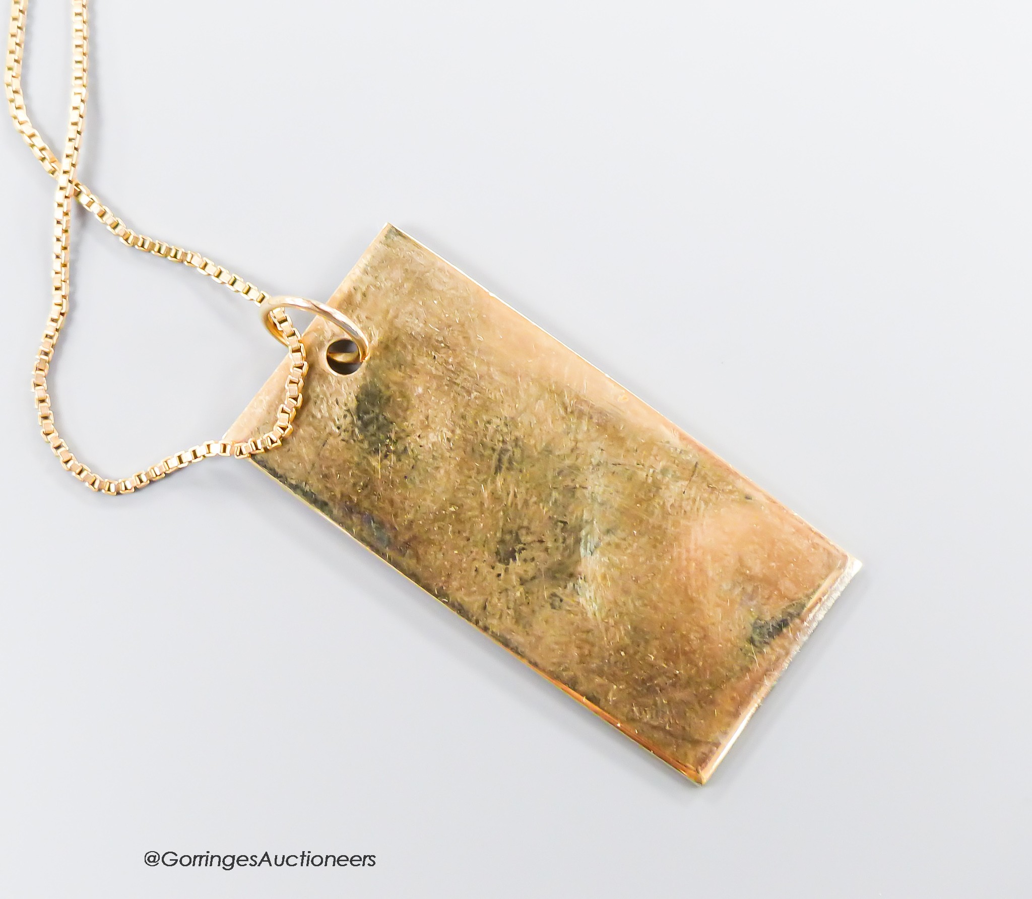 A modern 9ct gold ingot on a 9ct gold chain, chain 44cm, 9.4 grams.